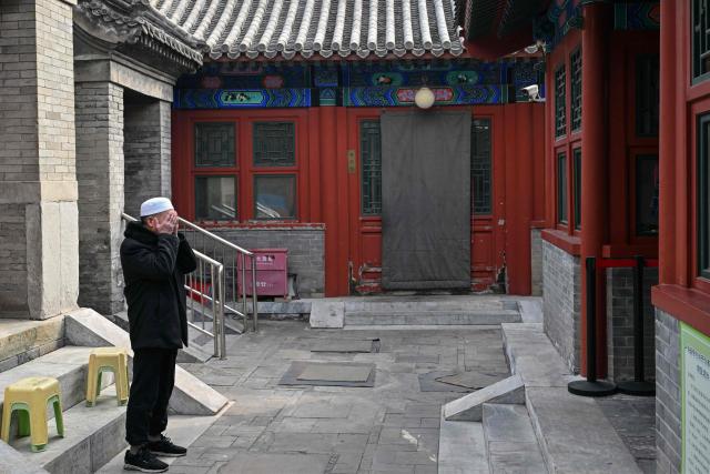 A Chinese Muslim calls for prayers during the holy month of Ramadan in Beijing on February 26, 2026. (Photo by ADEK BERRY / AFP)
