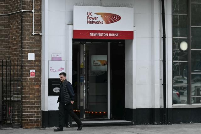 A man walks near the entrance of Britain's leading electricity distributor, UK Power Networks, in south London on February 26, 2026. French energy firm Engie said on February 25 it had signed an agreement to buy 100 percent of UK Power Networks electricity distributor for 10.5 billion pounds (14.2 billion USD). (Photo by JUSTIN TALLIS / AFP)