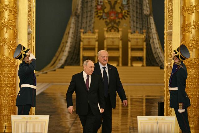 Russia's President Vladimir Putin (L) and Belarus' President Alexander Lukashenko (L) arrive to attend a meeting of the Supreme State Council of the Union State of Russia and Belarus in Moscow on February 26, 2026. (Photo by HECTOR RETAMAL / POOL / AFP)