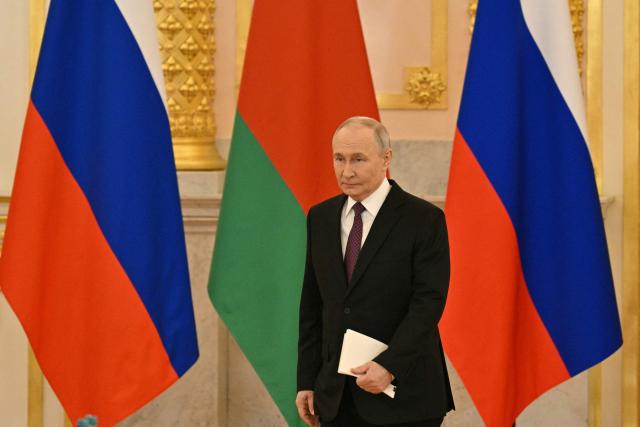 Russia's President Vladimir Putin arrives to attend a meeting of the Supreme State Council of the Union State of Russia and Belarus in Moscow on February 26, 2026. (Photo by HECTOR RETAMAL / POOL / AFP)