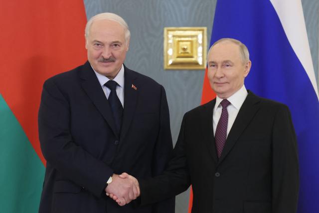 Russia's President Vladimir Putin (R) greets Belarus' President Alexander Lukashenko (L) prior to a meeting of the Supreme State Council of the Union State of Russia and Belarus in Moscow on February 26, 2026. (Photo by Maxim SHIPENKOV / POOL / AFP)