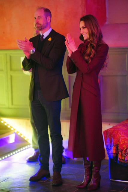 Britain's Prince William, Prince of Wales and Britain's Catherine, Princess of Wales applaud a choir during a visit to the Hanging Gardens in Llanidloes, central Wales on February 26, 2026. (Photo by Ben Birchall / POOL / AFP)