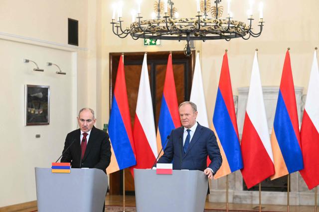 Poland's Prime Minister Donald Tusk (R) and Armenia's Prime Minister Nikol Pashinyan give a joint press conference following their talks in Warsaw on February 26, 2026. (Photo by Sergei GAPON / AFP)