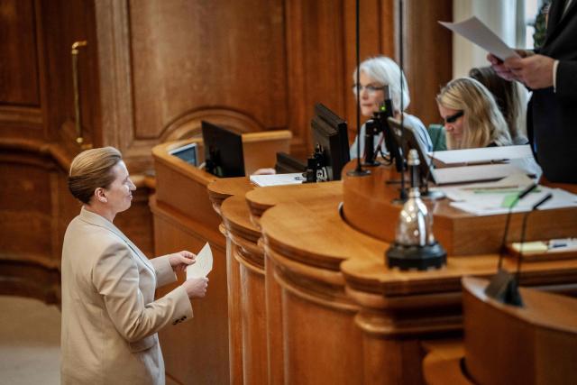 Danish Prime Minister Mette Frederiksen (L) submits a note to request a special remark in the Folketing Hall at Christiansborg in Copenhagen, Denmark, on February 26, 2026. Frederiksen said that she had scheduled this year's general election for March 24. (Photo by Mads Claus Rasmussen / Ritzau Scanpix / AFP) / Denmark OUT