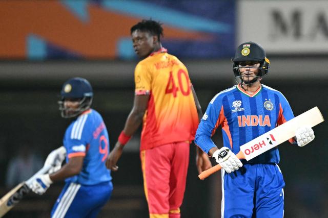 India's Abhishek Sharma (R) runs between the wickets Zimbabwe's Blessing Muzarabani (C) looks on during the 2026 ICC Men's T20 Cricket World Cup Super Eights match between India and Zimbabwe at the MA Chidambaram Stadium in Chennai on February 26, 2026. (Photo by Sajjad HUSSAIN / AFP)