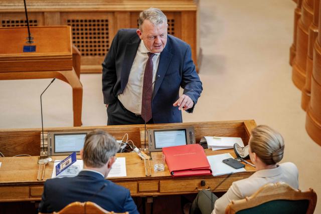 Danish Prime Minister Mette Frederiksen (R), Foreign Minister Lars Loekke Rasmussen (C) and Defense Minister Troels Lund Poulsen (L) attend a parliamentary session in the Folketing Hall at Christiansborg in Copenhagen, Denmark, on February 26, 2026. Frederiksen said that she had scheduled this year's general election for March 24. Denmark's Prime Minister Mette Frederiksen said that she had scheduled this year's general election for March 24. (Photo by Mads Claus Rasmussen / Ritzau Scanpix / AFP) / Denmark OUT