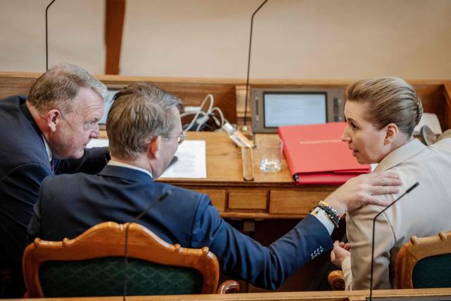 Danish Prime Minister Mette Frederiksen (R), Foreign Minister Lars Loekke Rasmussen (L) and Defense Minister Troels Lund Poulsen (C) attend a parliamentary session in the Folketing Hall at Christiansborg in Copenhagen, Denmark, on February 26, 2026. Frederiksen said that she had scheduled this year's general election for March 24. (Photo by Mads Claus Rasmussen / Ritzau Scanpix / AFP) / Denmark OUT