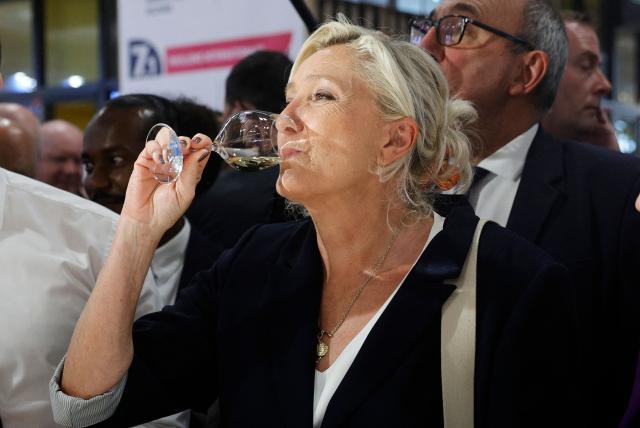 President of Rassemblement National parliamentary group Marine Le Pen drinks a glass of wine during her visit to the Paris International Agricultural Show (Salon de l'Agriculture) at Paris Expo Porte de Versailles in Paris on February 26, 2026. (Photo by GEOFFROY VAN DER HASSELT / AFP)