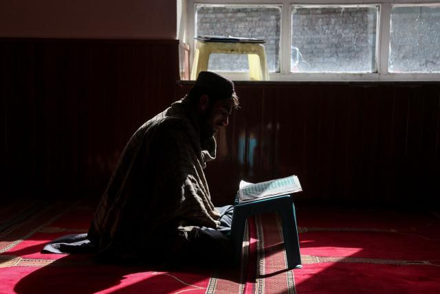 An Afghan man reads the holy Koran during the Islamic holy fasting month of Ramadan at a mosque in Ghazni on February 26, 2026. (Photo by Mohammad Faisal NAWEED / AFP)