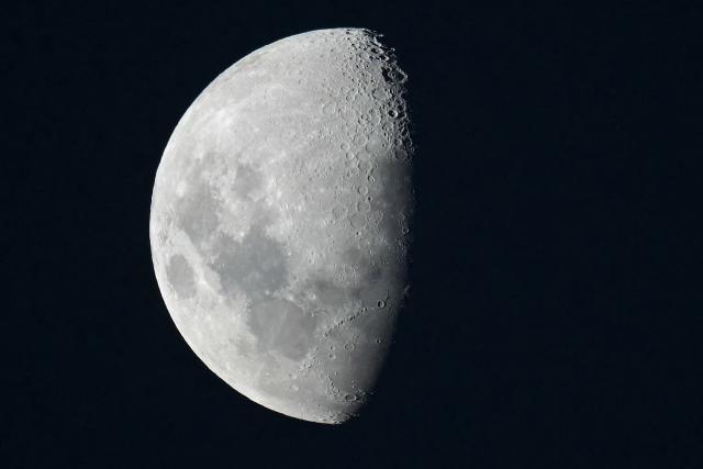 TOPSHOT - A half moon shines over Buenos Aires on February 25, 2026. (Photo by JUAN MABROMATA / AFP)
