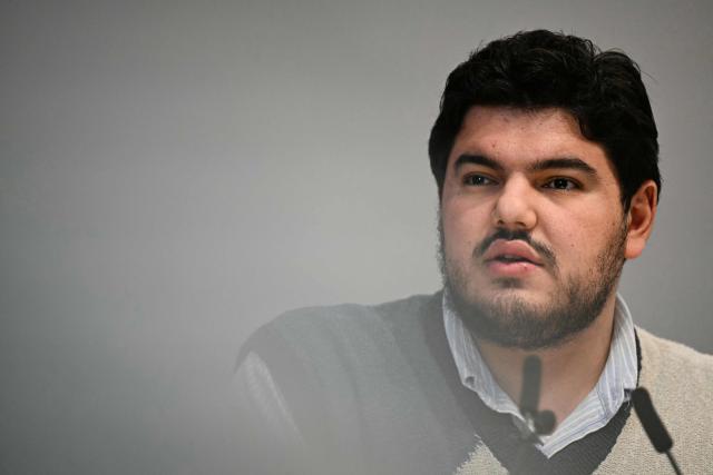 French anti-drug activist Amine Kessaci speaks during a press conference on the law proposal aimed to extend protection for whistleblowers against drug trafficking, proposed during the Les Ecologistes Party's parliamentary ‘niche’, at the Senate in Paris on February 26, 2026. The text proposed by Bas-Rhin MP Sandra Regol aims to enshrine in law a ‘mechanism for protecting individuals who report the influence of criminal networks’. Protection for victims, witnesses and informants already exists ‘within a judicial framework’, but the aim is to extend it to individuals outside this framework. (Photo by Anna KURTH / AFP)