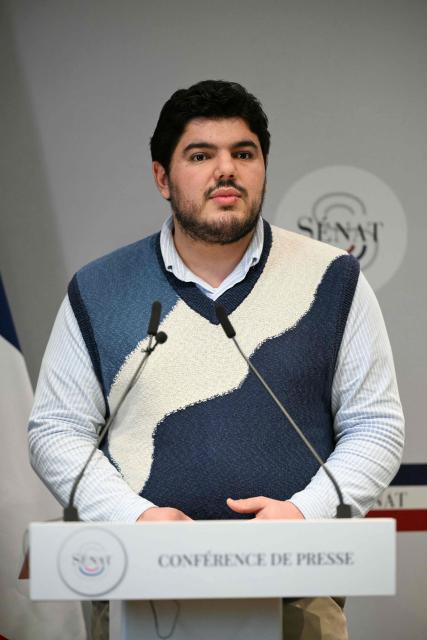 French anti-drug activist Amine Kessaci speaks during a press conference on the law proposal aimed to extend protection for whistleblowers against drug trafficking, proposed during the Les Ecologistes Party's parliamentary ‘niche’, at the Senate in Paris on February 26, 2026. The text proposed by Bas-Rhin MP Sandra Regol aims to enshrine in law a ‘mechanism for protecting individuals who report the influence of criminal networks’. Protection for victims, witnesses and informants already exists ‘within a judicial framework’, but the aim is to extend it to individuals outside this framework. (Photo by Anna KURTH / AFP)