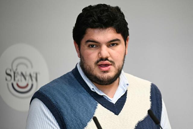 French anti-drug activist Amine Kessaci speaks during a press conference on the law proposal aimed to extend protection for whistleblowers against drug trafficking, proposed during the Les Ecologistes Party's parliamentary ‘niche’, at the Senate in Paris on February 26, 2026. The text proposed by Bas-Rhin MP Sandra Regol aims to enshrine in law a ‘mechanism for protecting individuals who report the influence of criminal networks’. Protection for victims, witnesses and informants already exists ‘within a judicial framework’, but the aim is to extend it to individuals outside this framework. (Photo by Anna KURTH / AFP)