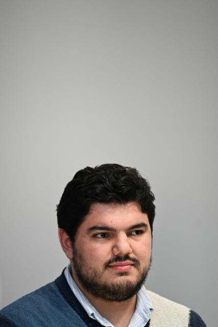 French anti-drug activist Amine Kessaci looks on during a press conference to on the law proposal aimed to extend protection for whistleblowers against drug trafficking, proposed during the Les Ecologistes Party's parliamentary ‘niche’, at the Senate in Paris on February 26, 2026. The text proposed by Bas-Rhin MP Sandra Regol aims to enshrine in law a ‘mechanism for protecting individuals who report the influence of criminal networks’. Protection for victims, witnesses and informants already exists ‘within a judicial framework’, but the aim is to extend it to individuals outside this framework. (Photo by Anna KURTH / AFP)