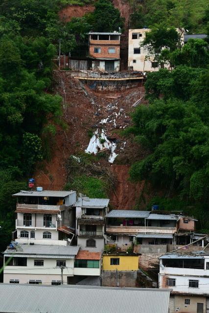 View of a landslide after heavy rainfall in the Tres Moinhos neighborhood in Juiz de Fora, Minas Gerais state, Brazil, on February 26, 2026. Despair hung over two cities in southeastern Brazil on February 25 as rescuers and residents searched for 21 people missing after torrential rains unleashed flooding and landslides that killed at least 46. (Photo by Pablo PORCIUNCULA / AFP)
