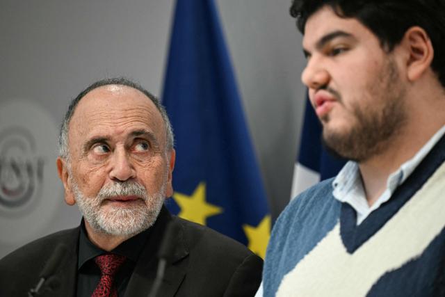 French Ecologist senator Guy Benarroche (L) and French anti-drug activist Amine Kessaci attend a press conference to detail the law proposal aimed to extend protection for whistleblowers against drug trafficking, proposed during the Les Ecologistes Party's parliamentary ‘niche’, at the Senate in Paris on February 26, 2026. The text proposed by Bas-Rhin MP Sandra Regol aims to enshrine in law a ‘mechanism for protecting individuals who report the influence of criminal networks’. Protection for victims, witnesses and informants already exists ‘within a judicial framework’, but the aim is to extend it to individuals outside this framework. (Photo by Anna KURTH / AFP)