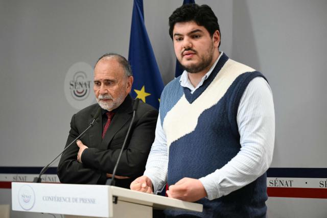 French Ecologist senator Guy Benarroche (L) and French anti-drug activist Amine Kessaci attend a press conference on the law proposal aimed to extend protection for whistleblowers against drug trafficking, proposed during the Les Ecologistes Party's parliamentary ‘niche’, at the Senate in Paris on February 26, 2026. The text proposed by Bas-Rhin MP Sandra Regol aims to enshrine in law a ‘mechanism for protecting individuals who report the influence of criminal networks’. Protection for victims, witnesses and informants already exists ‘within a judicial framework’, but the aim is to extend it to individuals outside this framework. (Photo by Anna KURTH / AFP)