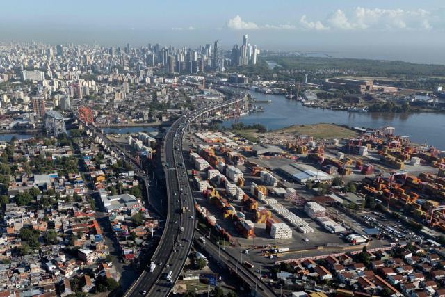 This aerial view shows Dr. Ricardo Balbin highway and containers at Dock Sud Port in Avellaneda, Buenos Aires province, Argentina, on February 26, 2026. (Photo by LUIS ROBAYO / AFP)