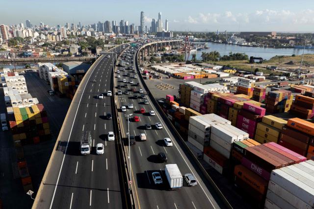 This aerial view shows Dr. Ricardo Balbin highway and containers at Dock Sud Port in Avellaneda, Buenos Aires province, Argentina, taken on February 26, 2026. (Photo by LUIS ROBAYO / AFP)