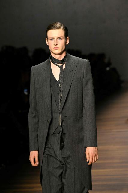 A model presents a creation during the Armani fashion show as part of the Milan Fashion Week Womens-Mens collection Fall-Winter 2026-2027, in Milan on February 26, 2026. (Photo by Andreas SOLARO / AFP)