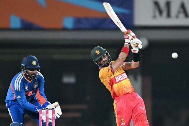 Zimbabwe's captain Sikandar Raza (R) plays a shot as India's wicketkeeper Sanju Samson (L) looks on during the 2026 ICC Men's T20 Cricket World Cup Super Eights match between India and Zimbabwe at the MA Chidambaram Stadium in Chennai on February 26, 2026. (Photo by Sajjad HUSSAIN / AFP)