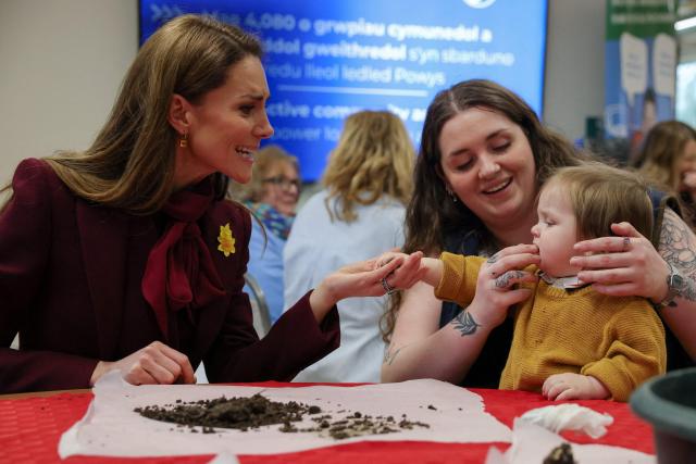 Britain's Catherine, Princess of Wales makes a seed bomb with a child during a visit to Hafan yr Afon, a hub for culture, community, and heritage, in the town of Newtown, rural Powys, central Wales on February 26, 2026. (Photo by Phil Noble / POOL / AFP)