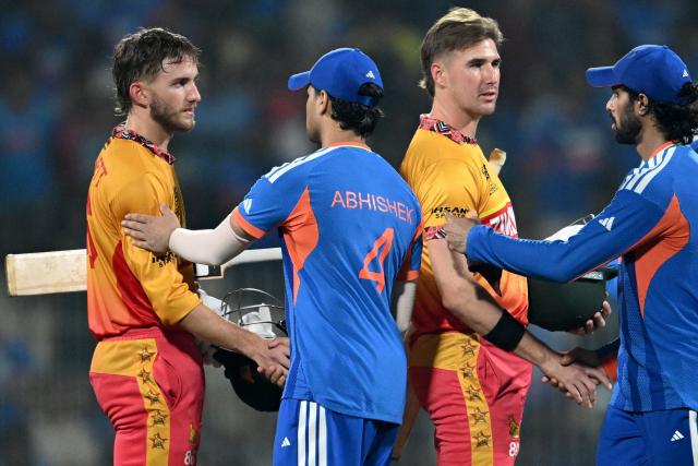 Zimbabwe's players congratulate India's Tilak Varma (R) and Abhishek Sharma after their win in the 2026 ICC Men's T20 Cricket World Cup Super Eights match between India and Zimbabwe at the MA Chidambaram Stadium in Chennai on February 26, 2026. (Photo by R. Satish BABU / AFP)