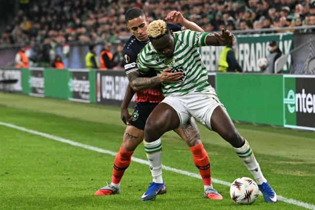 Ludogorets Razgrad's Spanish defender #17 Son (L) and Ferencvaros' Nigerian forward #11 Bamidele Yusuf vie for the ball during the UEFA Europa League knockout round playoff second leg football match Ferencvaros v Ludogorets Razgrad in Budapest, Hungary, on February 26, 2026. (Photo by Attila KISBENEDEK / AFP)