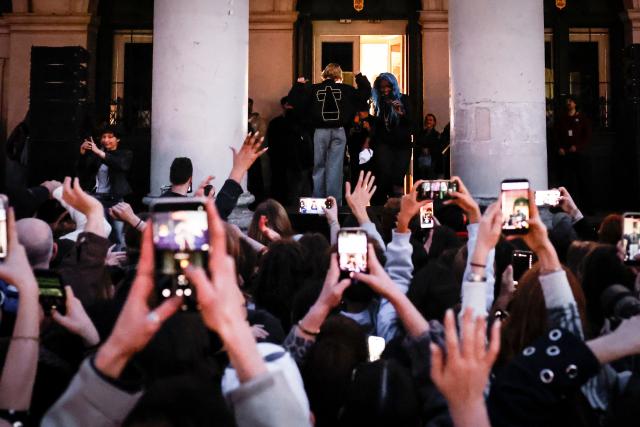 Belgian singer Angele appears wearing a jacket from the French electronic group Justice on the square de la Monnaie in Brussels on February 26, 2026 to showcase on the eve of the release of her new song "What You Want". (Photo by Simon Wohlfahrt / AFP)