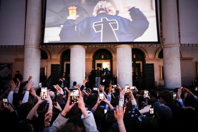 Belgian singer Angele appears wearing a jacket from the French electronic group Justice on the square de la Monnaie in Brussels on February 26, 2026 to showcase on the eve of the release of her new song "What You Want". (Photo by Simon Wohlfahrt / AFP)