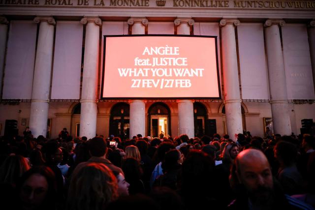 People wait to see Belgian singer Angele  on the square de la Monnaie in Brussels on February 26, 2026 for her showcase on the eve of the release of her new song "What You Want". (Photo by Simon Wohlfahrt / AFP)