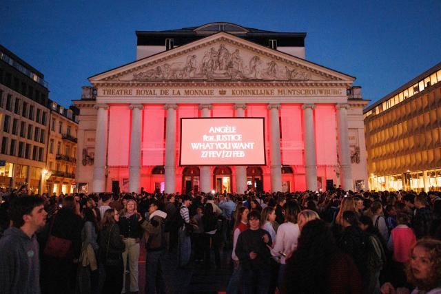 People wait to see Belgian singer Angele  on the square de la Monnaie in Brussels on February 26, 2026 for her showcase on the eve of the release of her new song "What You Want". (Photo by Simon Wohlfahrt / AFP)