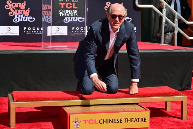 US producer John Davis signs his name as he attends his hand and footprint ceremony at the TCL Chinese theatre in Hollywood, California on February 26, 2026. (Photo by Frederic J. Brown / AFP)