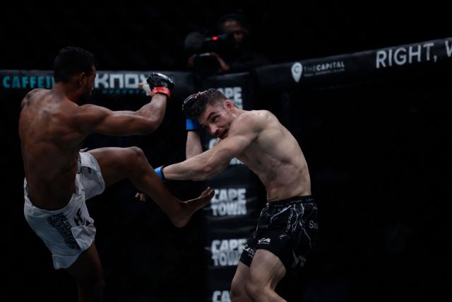 South Africa Adrian Sanchez (L) throws a kick during his fight against Brazil Jefferson Pereira (R) in their flyweight bout for the Extreme Fighting Championship (EFC) Matchups in Cape Town on February 26, 2026. (Photo by GIANLUIGI GUERCIA / AFP)