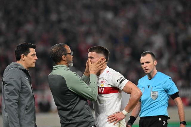 Stuttgart's Bosnian forward #09 Ermedin Demirovic (2nd R) receives medical treatment during the UEFA Europa League knockout round playoff second leg football match VfB Stuttgart v Celtic in Stuttgart, southern Germany, on February 26, 2026. (Photo by THOMAS KIENZLE / AFP)