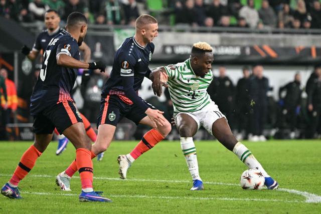 Ferencvaros' Nigerian forward #11 Bamidele Yusuf (R) and Ludogorets Razgrad's Bulgarian defender #03 Anton Nedyalkov (C) vie for the ball during the UEFA Europa League knockout round playoff second leg football match Ferencvaros v Ludogorets Razgrad in Budapest, Hungary, on February 26, 2026. (Photo by Attila KISBENEDEK / AFP)