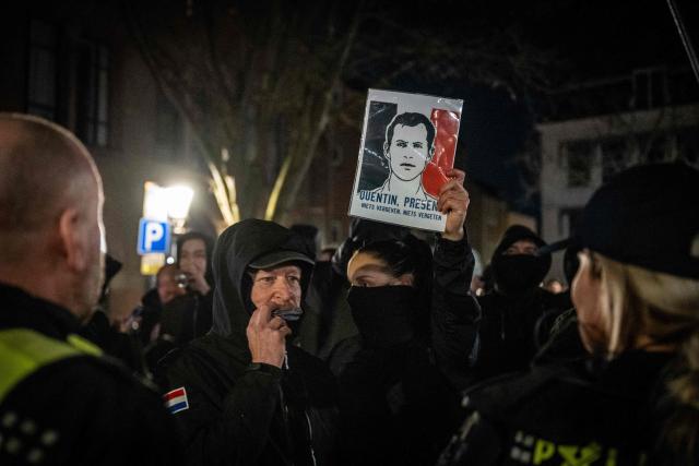 Attendees face police as they take part in a gathering by Defend Netherlands in tribute to French far-right activist Quentin Deranque, who died after being attacked on the sidelines of a far-right protest against a La France Insoumise (LFI) event, at the ACU political and cultural centre in Utrecht on February 26, 2026. Deranque, 23, died from head injuries following clashes between radical-left and far-right supporters on the sidelines of a February 12 protest against a politician from the left-wing LFI party in Lyon. (Photo by Josh Walet / ANP / AFP) / Netherlands OUT