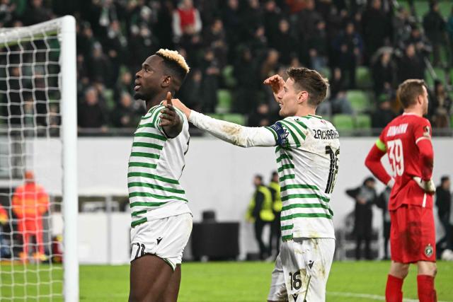 Ferencvaros' Nigerian forward #11 Bamidele Yusuf (L) and Ferencvaros' Norwegian midfielder #16 Kristoffer Zachariassen (C) celebrate after winning the UEFA Europa League knockout round playoff second leg football match Ferencvaros v Ludogorets Razgrad in Budapest, Hungary, on February 26, 2026. (Photo by Attila KISBENEDEK / AFP)