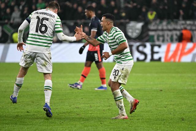 Ferencvaros' Norwegian midfielder #16 Kristoffer Zachariassen (L) and Ferencvaros' Brazilian midfielder #33 Cadu celebrate after winning the UEFA Europa League knockout round playoff second leg football match Ferencvaros v Ludogorets Razgrad in Budapest, Hungary, on February 26, 2026. (Photo by Attila KISBENEDEK / AFP)