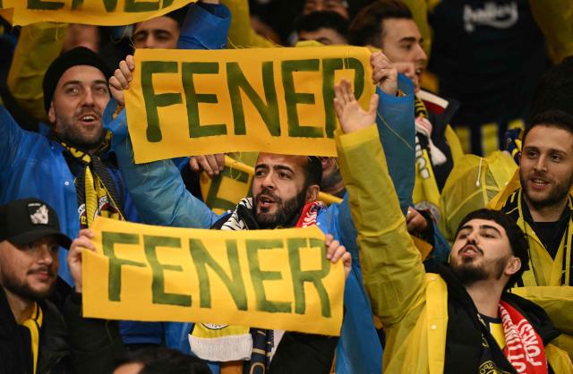 Fenerbahce fans chant as they wait for kick-off in the UEFA Europa League Knockout Round Play-off second-leg football match between Nottingham Forest and Fenerbahce SK at The City Ground in Nottingham, central England, on February 26, 2026. (Photo by Oli SCARFF / AFP)