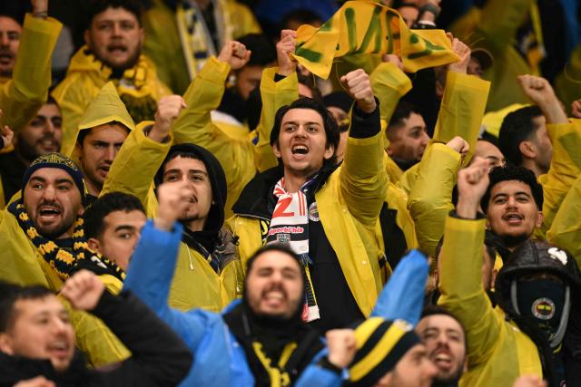Fenerbahce fans chant as they wait for kick-off in the UEFA Europa League Knockout Round Play-off second-leg football match between Nottingham Forest and Fenerbahce SK at The City Ground in Nottingham, central England, on February 26, 2026. (Photo by Oli SCARFF / AFP)