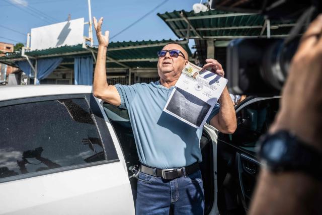 Venezuelan prisoner Camilo Roso Suarez celebrates after his release from El Rodeo I prison in Guatire, Miranda state, Venezuela, on February 26, 2026. Camilo Roso, 65, sentenced to five years in prison in connection with the humanitarian aid requested by then-opposition leader Juan Guaidó on the border with Colombia, completed his sentence on January 8. (Photo by Maryorin Mendez / AFP)