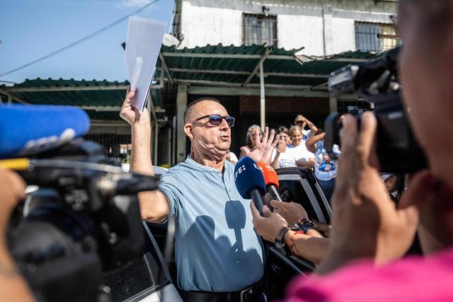 Venezuelan prisoner Camilo Roso Suarez celebrates after his release from El Rodeo I prison in Guatire, Miranda state, Venezuela, on February 26, 2026. Camilo Roso, 65, sentenced to five years in prison in connection with the humanitarian aid requested by then-opposition leader Juan Guaidó on the border with Colombia, completed his sentence on January 8. (Photo by Maryorin Mendez / AFP)