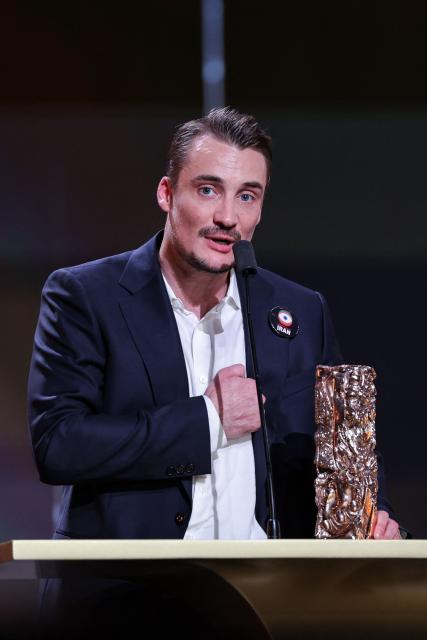 French actor Pierre Lottin delivers a speech with his trophy after winning the Best Actor in a Supporting Role award for The The Stranger (L'Etranger) during the 51st edition of the Cesar Film Awards ceremony at the Olympia venue in Paris on February 26, 2026. (Photo by Thomas SAMSON / AFP)