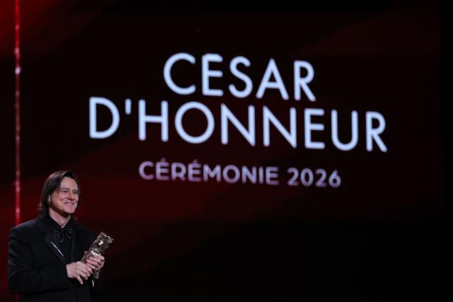 Canadian actor Jim Carrey holds his honorary Cesar award during the 51st edition of the Cesar Film Awards ceremony at the Olympia venue in Paris on February 26, 2026. (Photo by Thomas SAMSON / AFP)