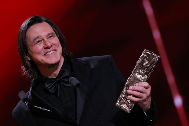 Canadian actor Jim Carrey reacts as he holds his honorary Cesar award during the 51st edition of the Cesar Film Awards ceremony at the Olympia venue in Paris on February 26, 2026. (Photo by Thomas SAMSON / AFP)