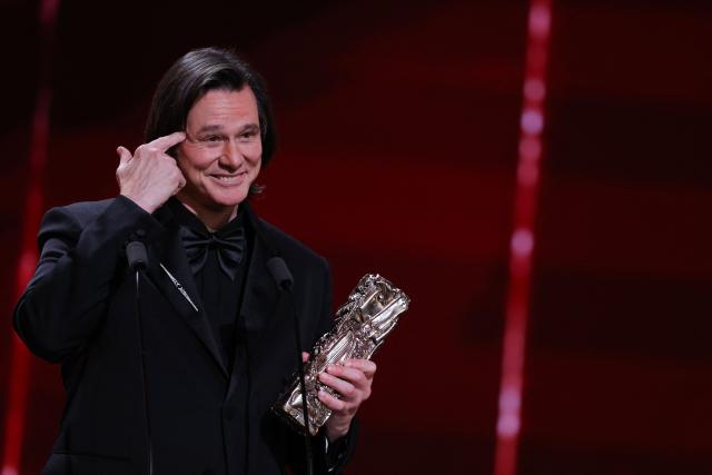 TOPSHOT - Canadian actor Jim Carrey reacts as he holds his honorary Cesar award during the 51st edition of the Cesar Film Awards ceremony at the Olympia venue in Paris on February 26, 2026. (Photo by Thomas SAMSON / AFP)