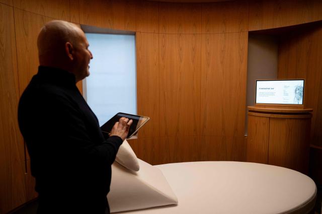 Jerome Salomon, French former Director General of Health and now medical and scientific director of Zoi, a start-up offering personalised medical check-ups, uses a tablet to control a screen remotely during a visit of Zoi's medical centre in Paris on February 24, 2026. (Photo by Anna KURTH / AFP)