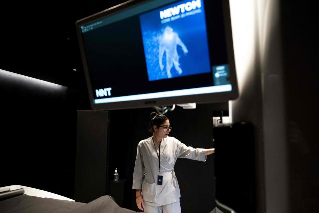 Laura, a medical radiology technician, works inside the 'Cone Beam Computed Tomography' (CBCT) room at Zoi's medical centre, a start-up offering personalised medical check-ups in Paris on February 24, 2026. (Photo by Anna KURTH / AFP)