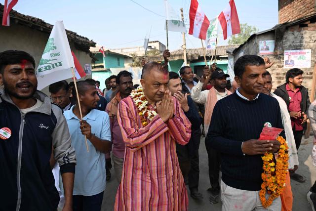 (FILES) Nepali Congress party's president and election candidate Gagan Thapa (C) greets supporters during door-to-door campaign in Sarlahi on February 21, 2026. Supporters chant the name of Gagan Thapa as he campaigns in Nepal's first election since deadly youth-led protests toppled the government, presenting himself as the face of generational change. (Photo by PRAKASH MATHEMA / AFP)